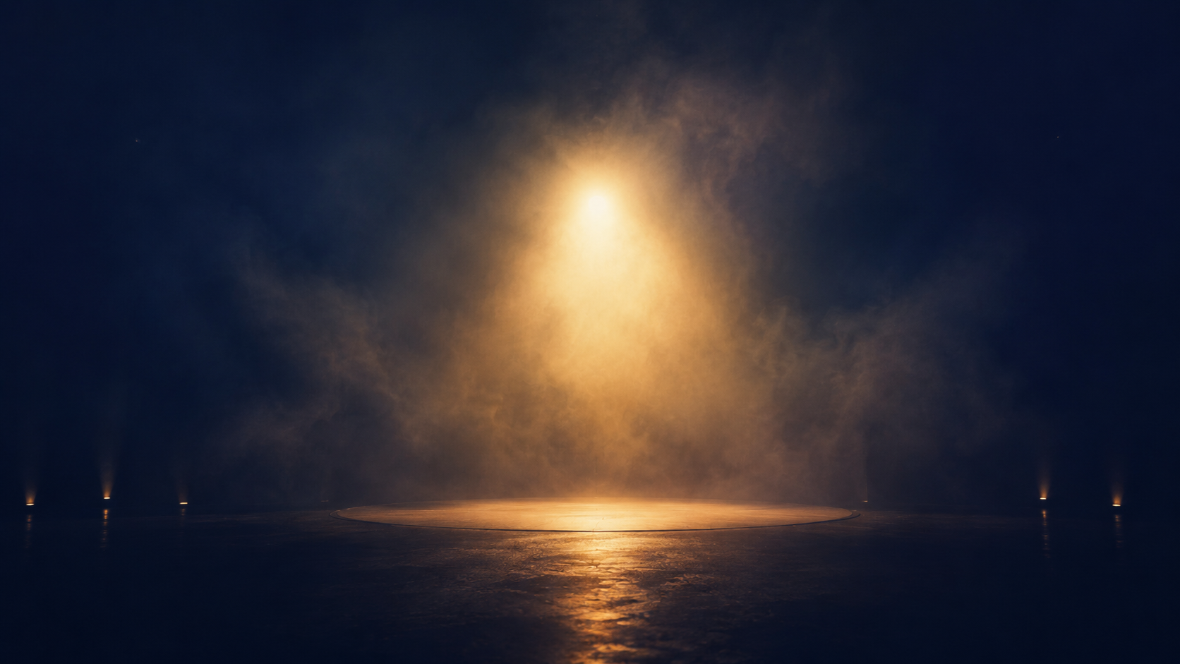 Empty stage, gold rim light through haze